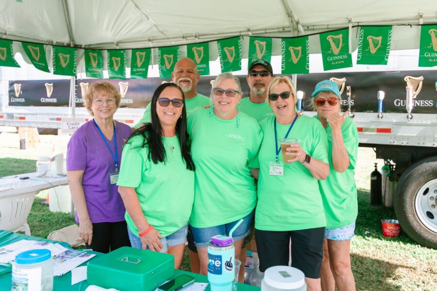 a group of people standing under a tent