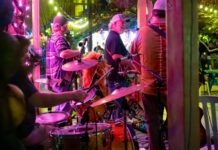 IN PICTURES: ANNUAL BLUEGRASS FESTIVAL BRINGS TOE-TAPPING TUNES AT FLORIDA KEYS BREWING CO. a group of people that are playing drums