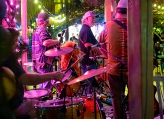 IN PICTURES: ANNUAL BLUEGRASS FESTIVAL BRINGS TOE-TAPPING TUNES AT FLORIDA KEYS BREWING CO. a group of people that are playing drums