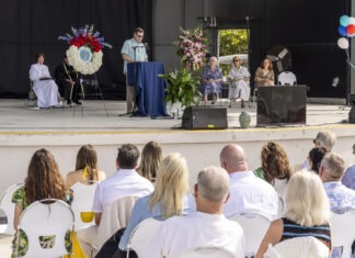 a group of people sitting in front of a stage