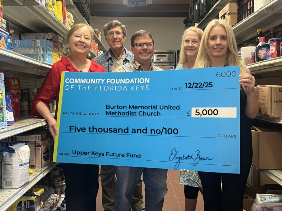 a group of people holding a large check in a store