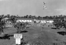 a black and white photo of a building and a flag