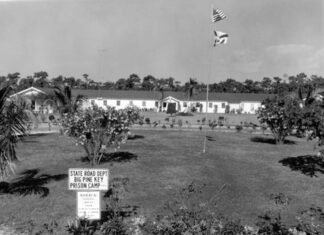 COLLEGE WORKING TO PUT BIG PINE SITE TO USE a black and white photo of a building and a flag