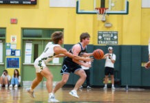 a group of young men playing a game of basketball