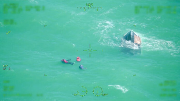 a couple of people in the water with a boat