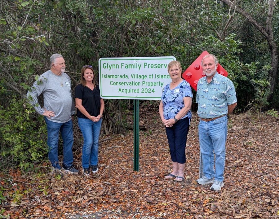 a group of people standing in front of a sign
