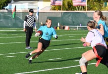 MARATHON MERMAIDS FLAG FOOTBALL LOOKS TO KEEP LOCKDOWN DEFENSE INTACT a group of girls playing a game of football