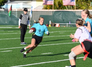 MARATHON MERMAIDS FLAG FOOTBALL LOOKS TO KEEP LOCKDOWN DEFENSE INTACT a group of girls playing a game of football