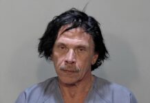 a mug shot of a man with black hair