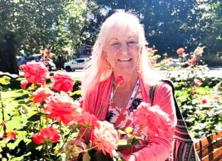 ARTIST IN RESIDENCE BRINGS FORMAL ART TRAINING TO JUST OLDER YOUTH ORGANIZATION a woman is sitting on a bench with flowers