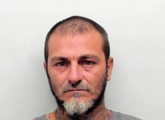 a man with a beard and tattoos on his face