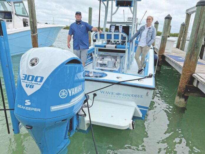 two men standing on a boat in the water