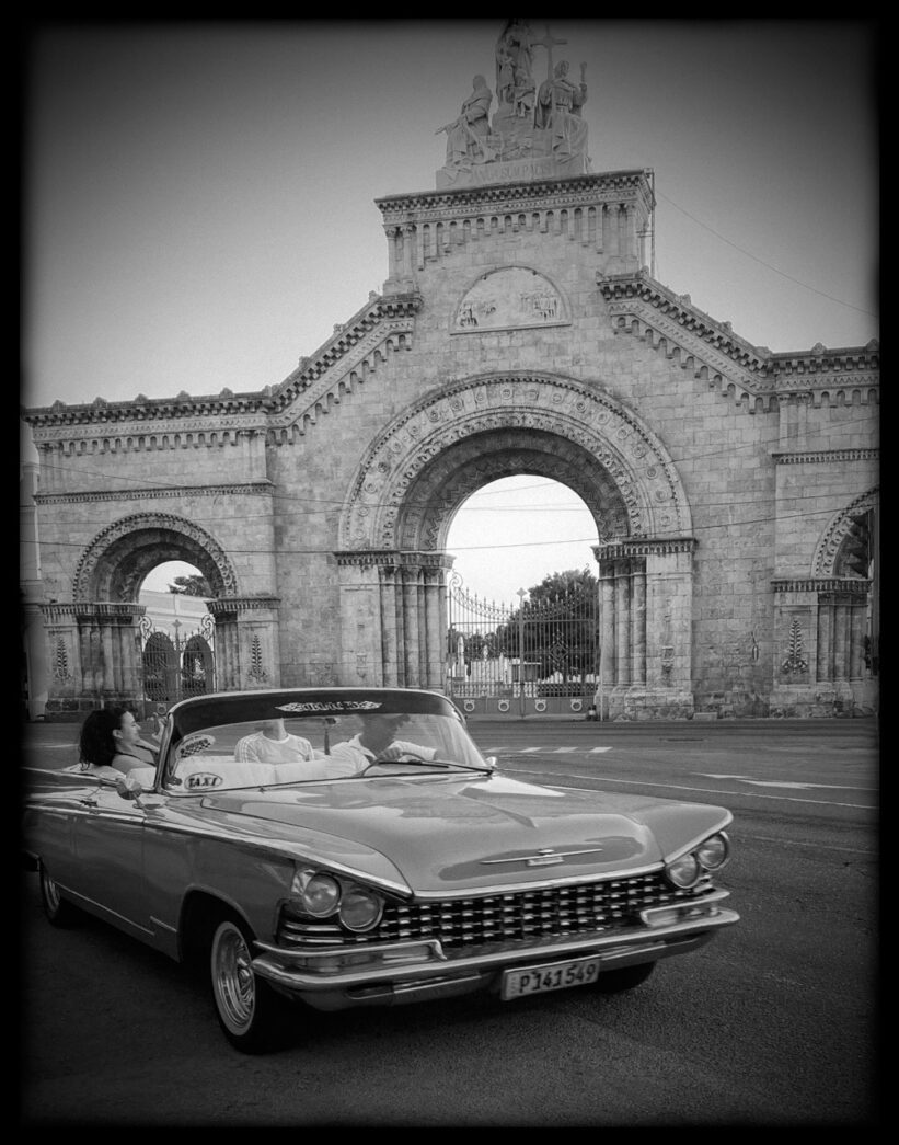 an old car parked in front of a building
