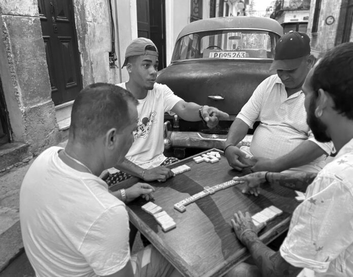 a group of men sitting around a table playing a game