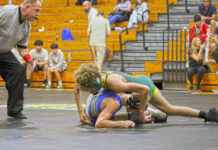WRESTLERS HIT THE MATS IN TAVERNIER FOR SATURDAY NIGHT SHOWDOWN a wrestling match with a referee looking on