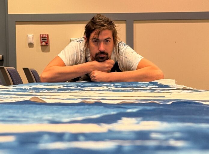 a man sitting at a table with his arms crossed