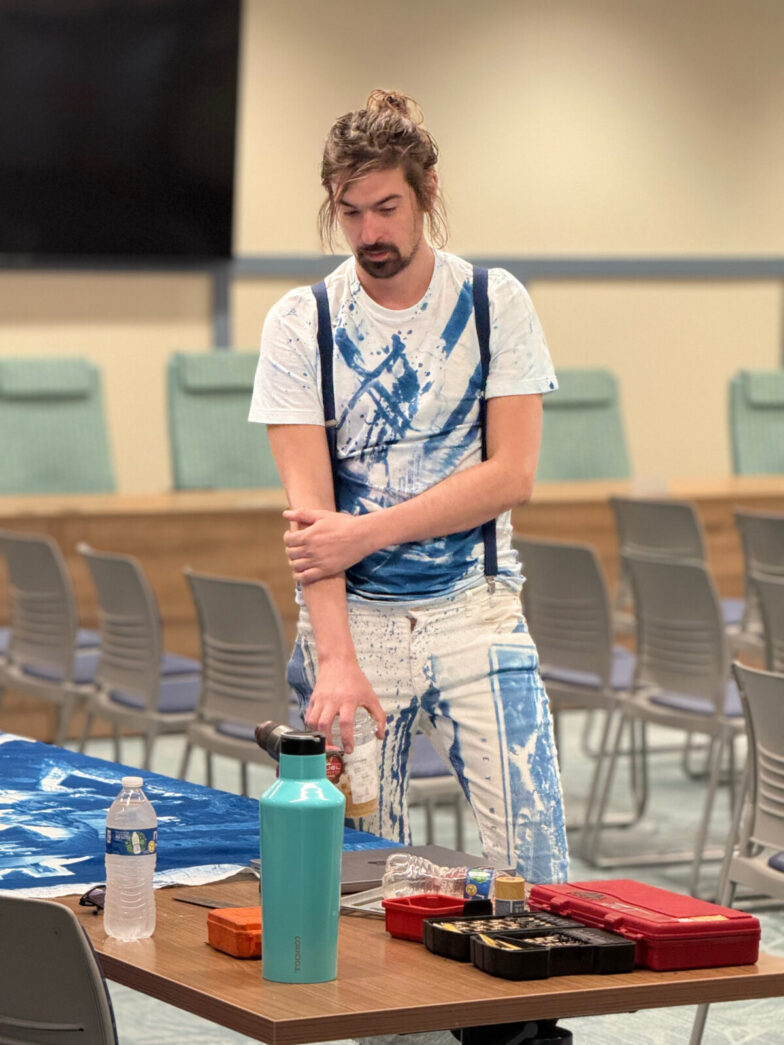 a man standing on a table with a water bottle