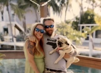RALLY FOR ‘ROACH’: WEEKEND BENEFIT FUNDS ISLAND FISH CO. BARTENDER’S BATTLE WITH CANCER a man and a woman pose for a picture with a dog