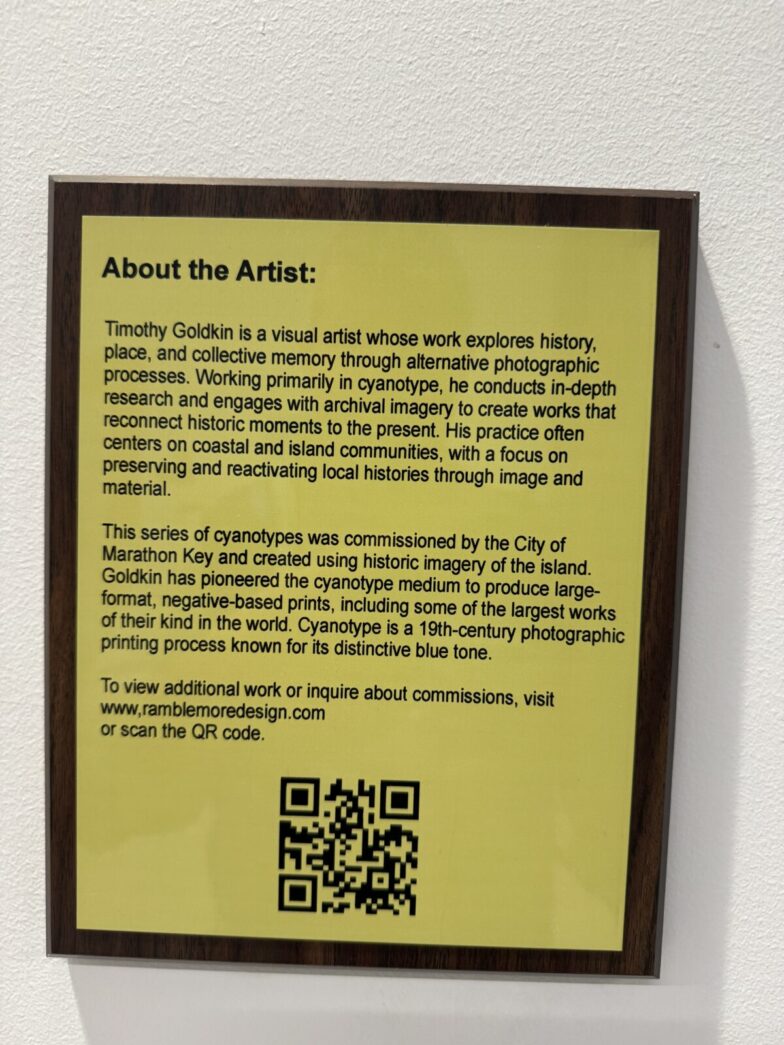 a sign on a wall that says about the artist