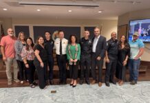 a group of people standing in front of a tv