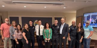 a group of people standing in front of a tv