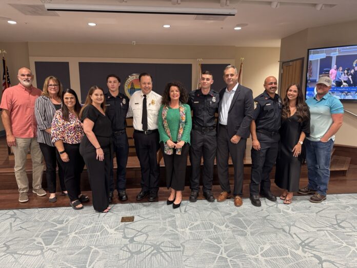 a group of people standing in front of a tv