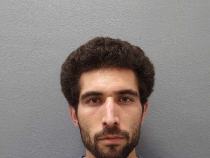 a man with a beard is looking at the camera