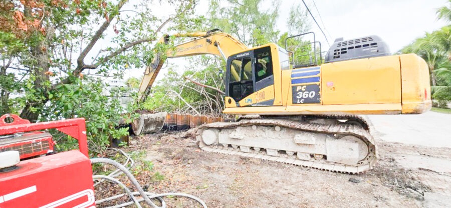 a yellow bulldozer sitting on top of a dirt field