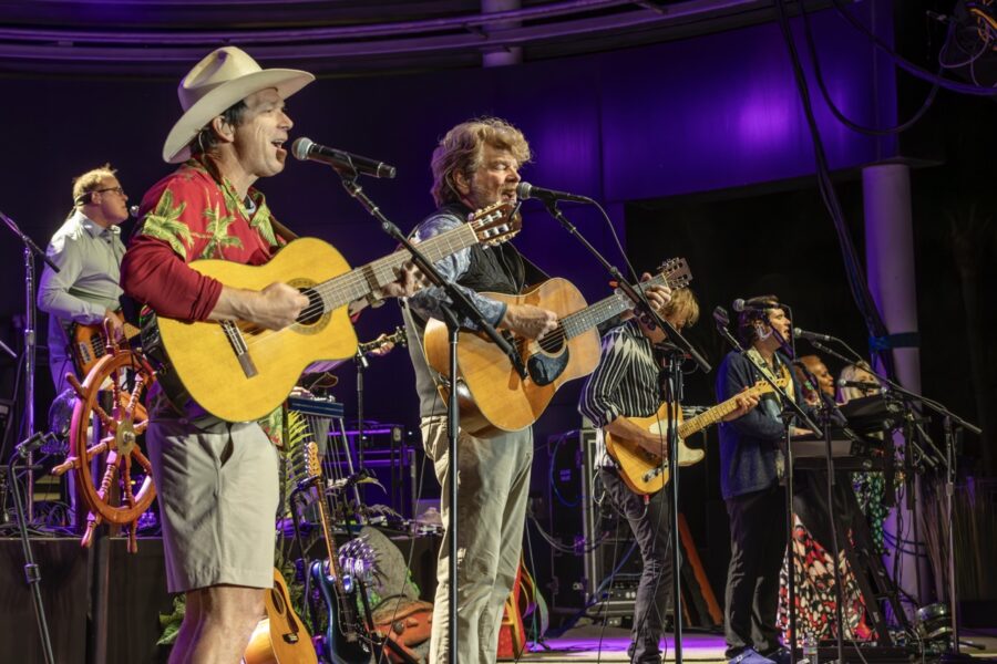 a group of men on stage with guitars