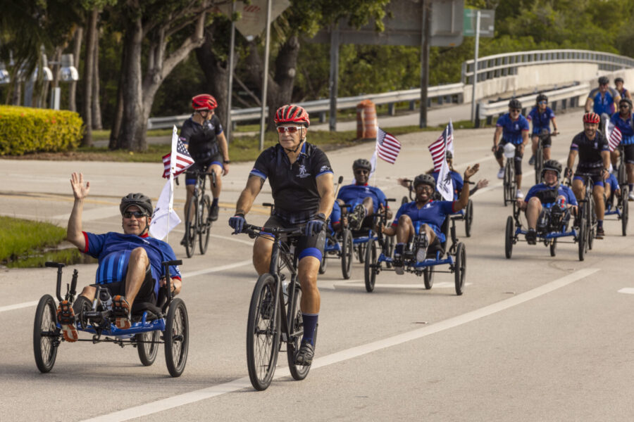 a group of people riding bikes down a street