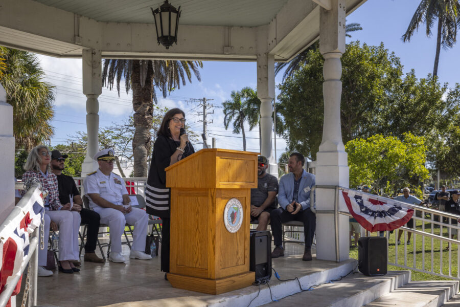 a woman standing at a podium in front of a crowd