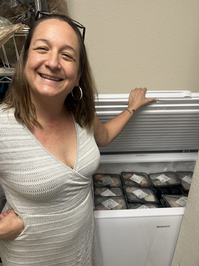 a woman standing in front of an open refrigerator