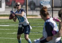ANNUAL WOMEN’S FLAG FOOTBALL TOURNAMENT RETURNS TO KEY WEST THIS WEEKEND a woman holding a football on top of a field
