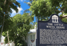 LADIES FIRST: SPECIAL EVENT FOCUSES ON FIRST LADIES a sign in front of a fence that says the little white house
