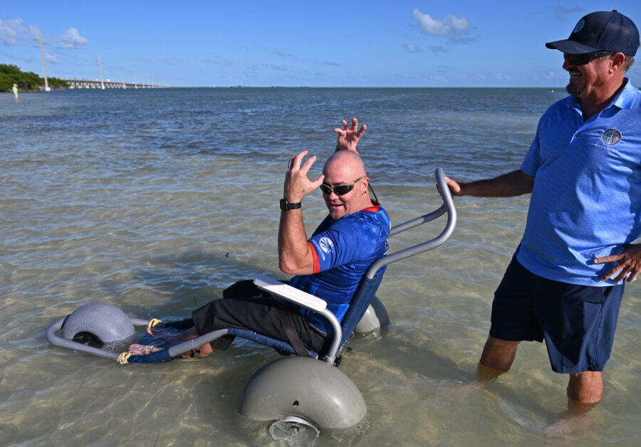 a man sitting in a chair in the water