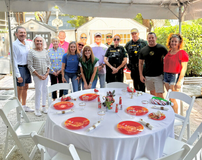 a group of people standing around a table