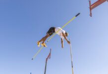 POLE VAULTERS RAISE THE BAR; THEN CLEAR IT AT KEY WEST’S HIGGS BEACH a man flying through the air while riding skis