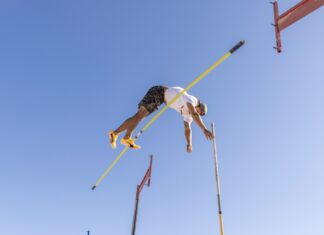 POLE VAULTERS RAISE THE BAR; THEN CLEAR IT AT KEY WEST’S HIGGS BEACH a man flying through the air while riding skis
