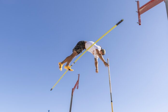 a man flying through the air while riding skis