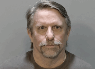 a mug shot of a man with a mustache