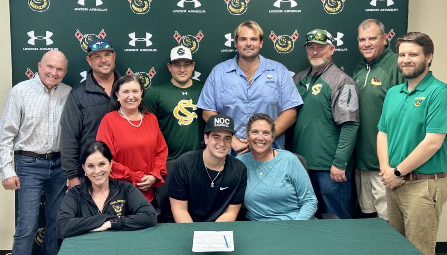 a group of people standing around a table