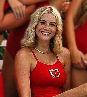 a group of women in red dresses sitting next to each other