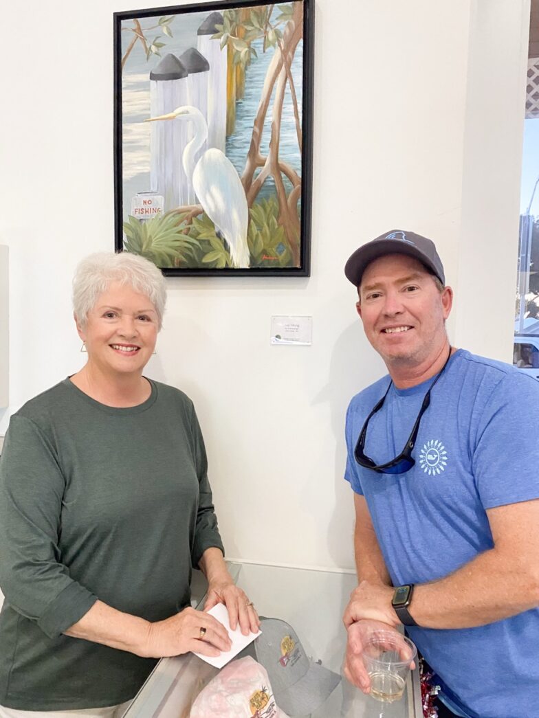 a man and a woman standing in front of a cake
