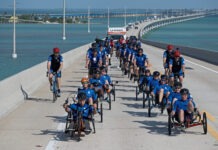 a group of people riding bikes down a road