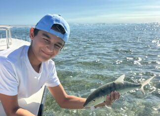 FLORIDA KEYS FISH REPORT: BONEFISH AND PERMIT HEATING UP a man holding a fish on a boat