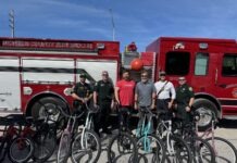 a group of men standing in front of a fire truck