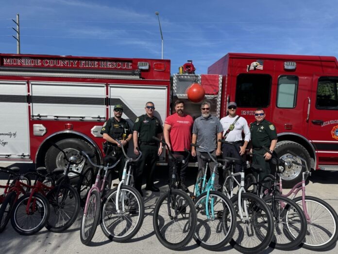 bike donation a group of men standing in front of a fire truck