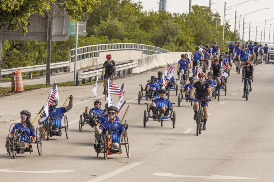 a group of people riding bikes down a street