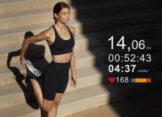 a woman in a black sports bra top and black shorts standing in front of a