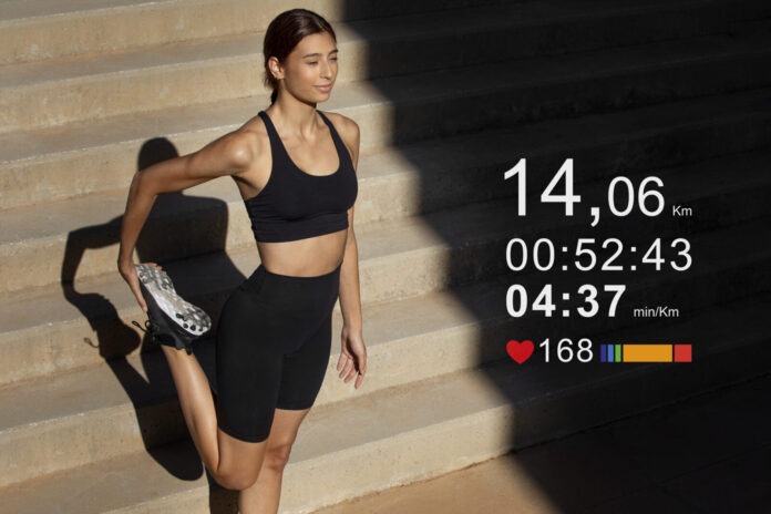 a woman in a black sports bra top and black shorts standing in front of a